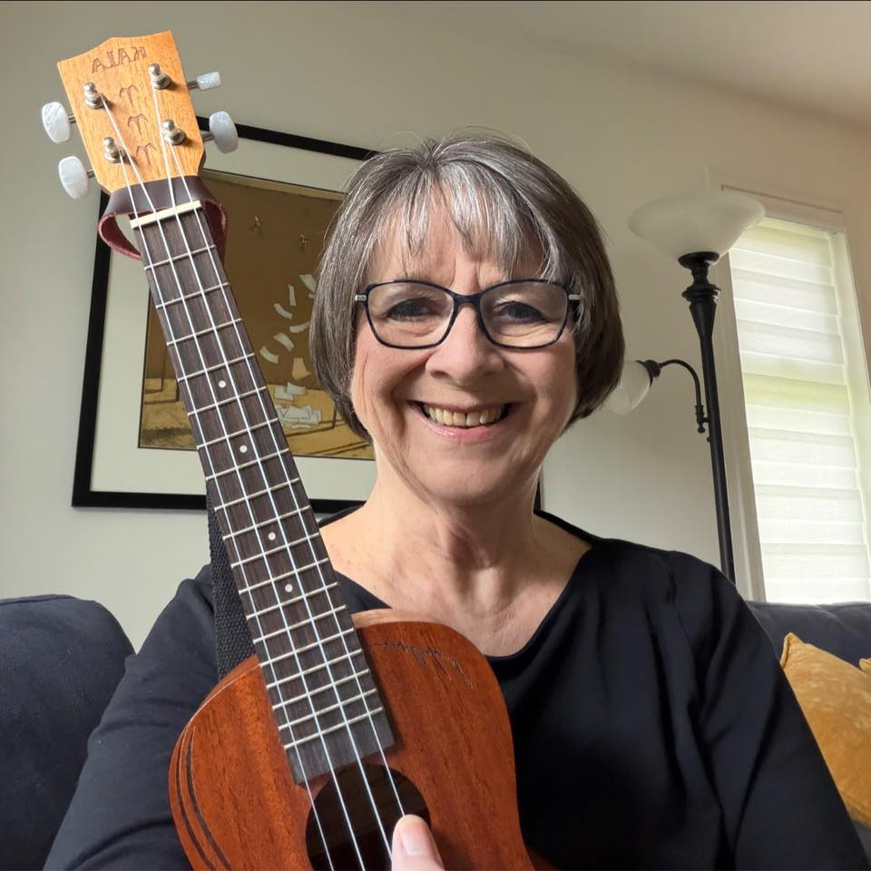 Shelley smiling with a ukulele